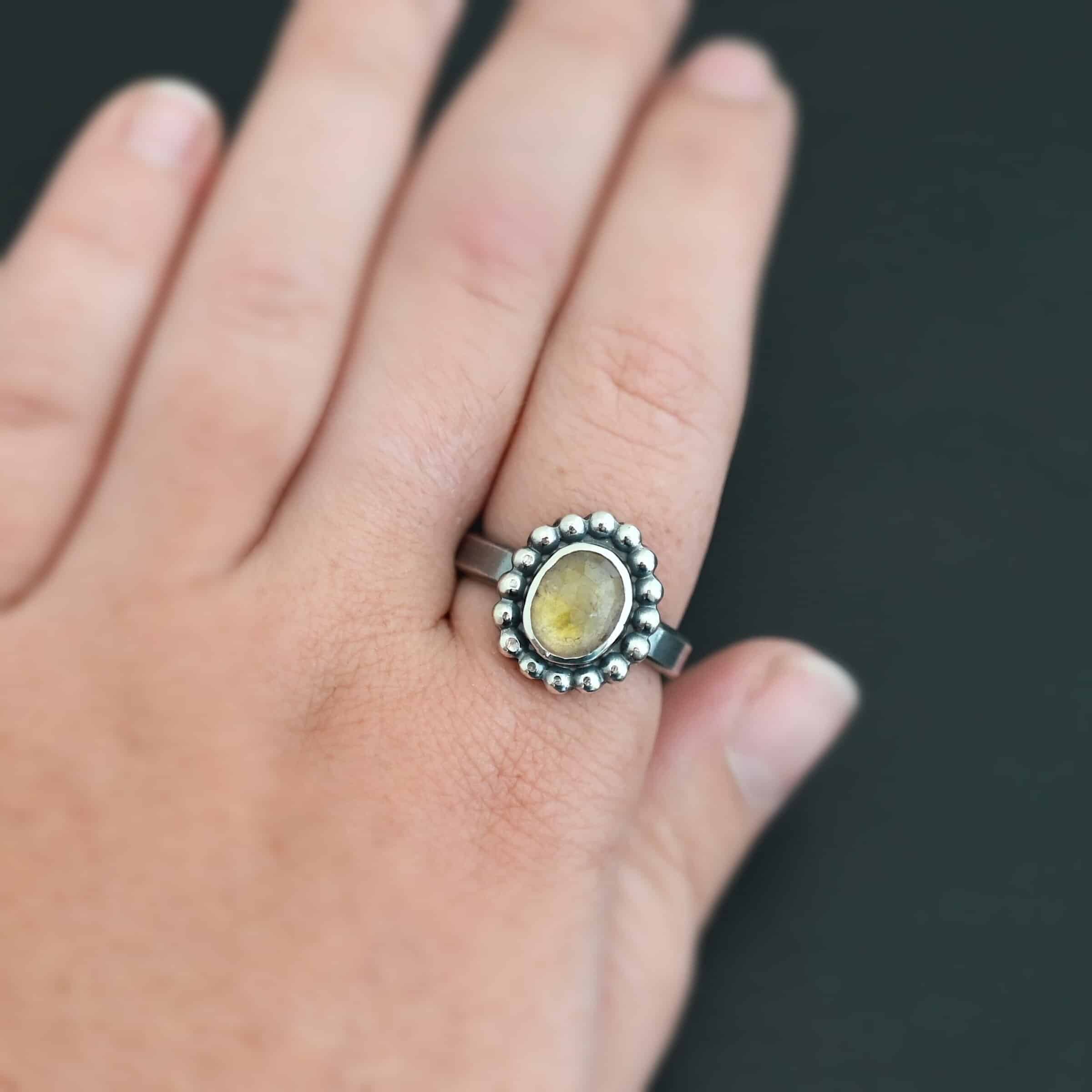 Radiant Sun Ring "Radiant Sun" Ring. Sterling Silver & Citrine. There is an oval, vertical citrine in the center with balls of silver circling all the way around it. Ring band is smooth & lightly oxidized.