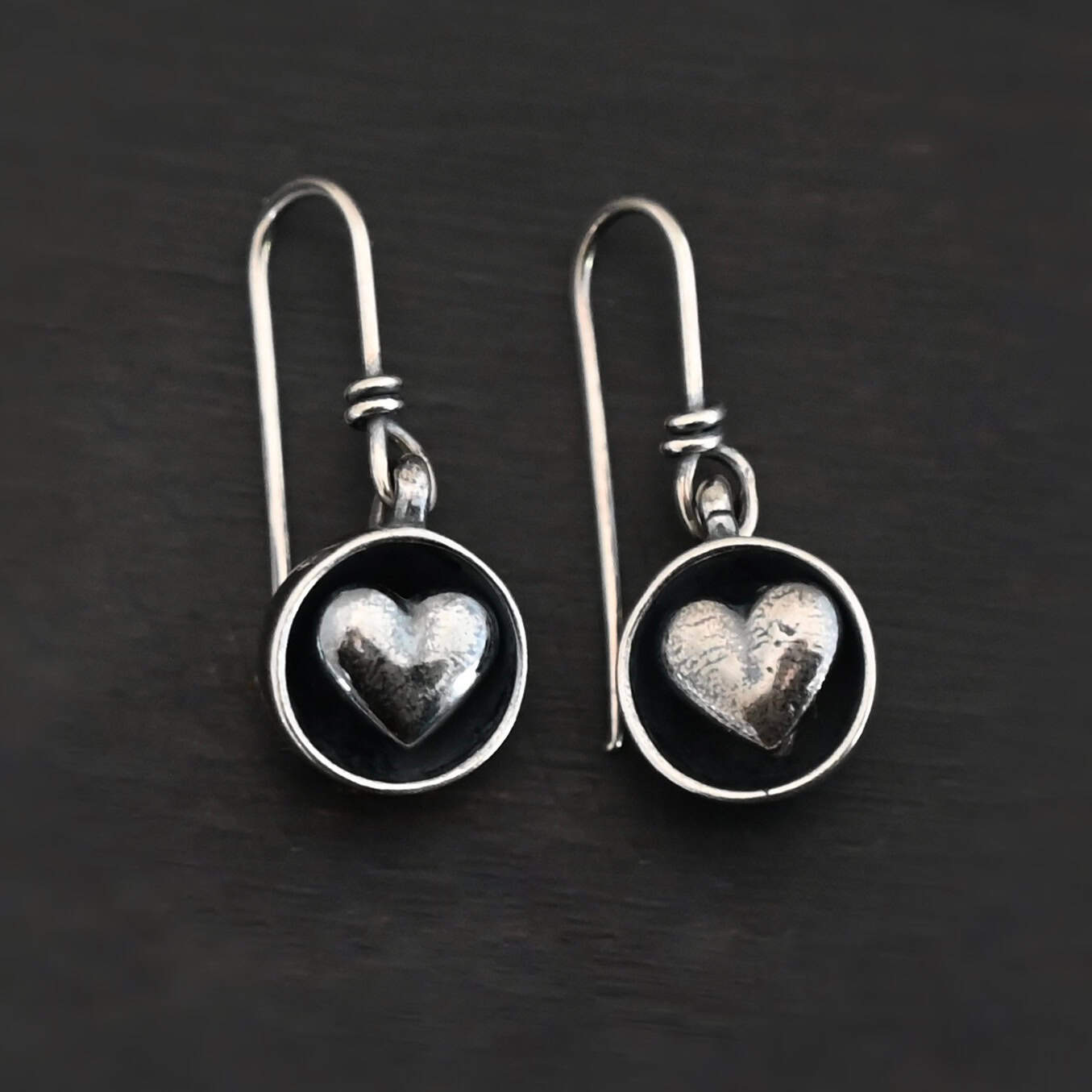 "Cups Of Love" Earrings. Earrings have sterling silver french hook ear wires. Hanging at the bottom of each is a small silver "cup" with a silver heart in the center of it.