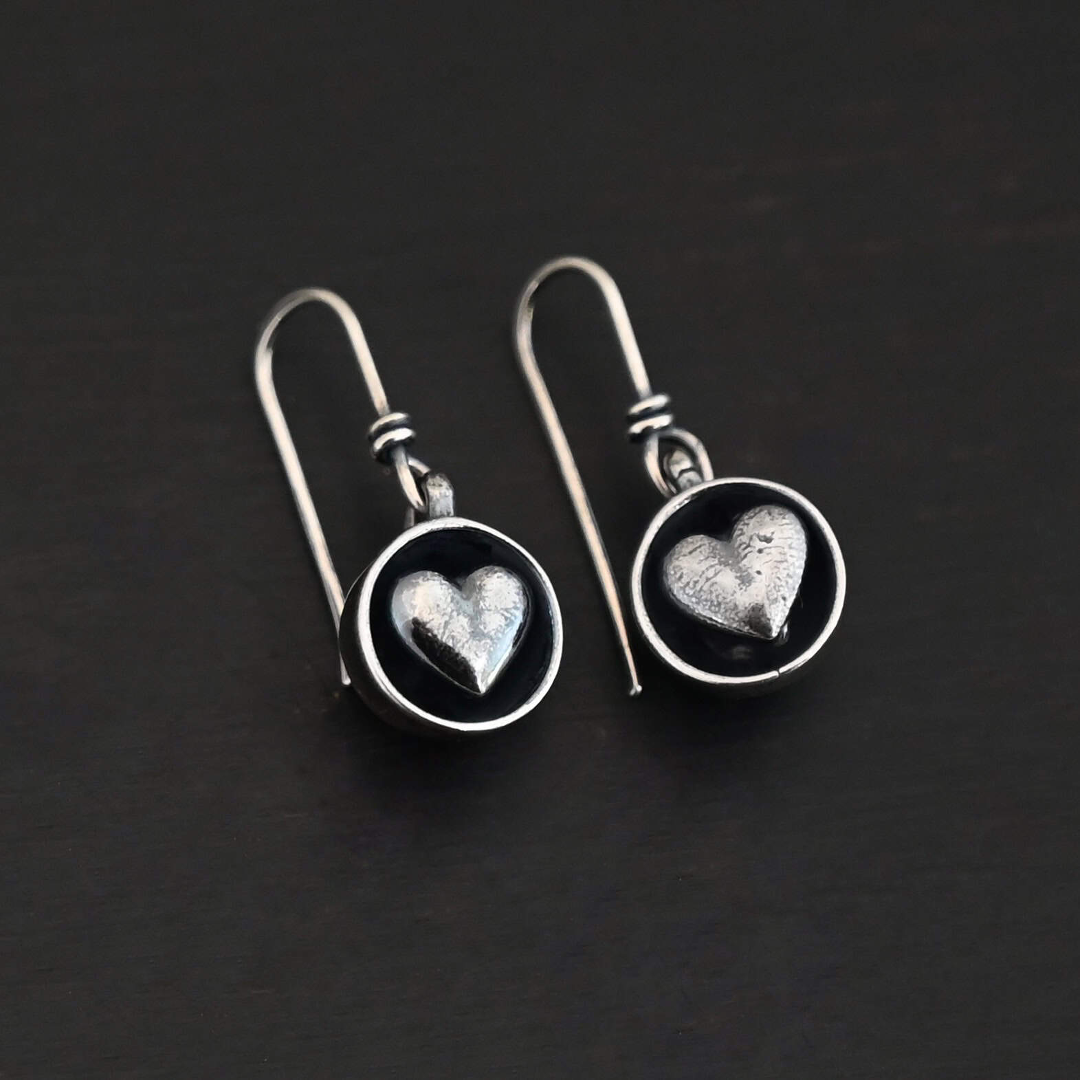 "Cups Of Love" Earrings. Earrings have sterling silver french hook ear wires. Hanging at the bottom of each is a small silver "cup" with a silver heart in the center of it.