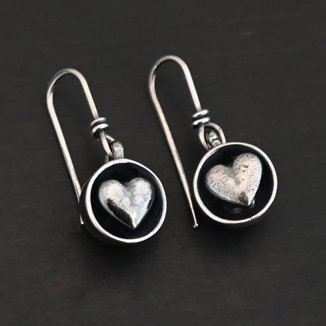 "Cups Of Love" Earrings. Earrings have sterling silver french hook ear wires. Hanging at the bottom of each is a small silver "cup" with a silver heart in the center of it.