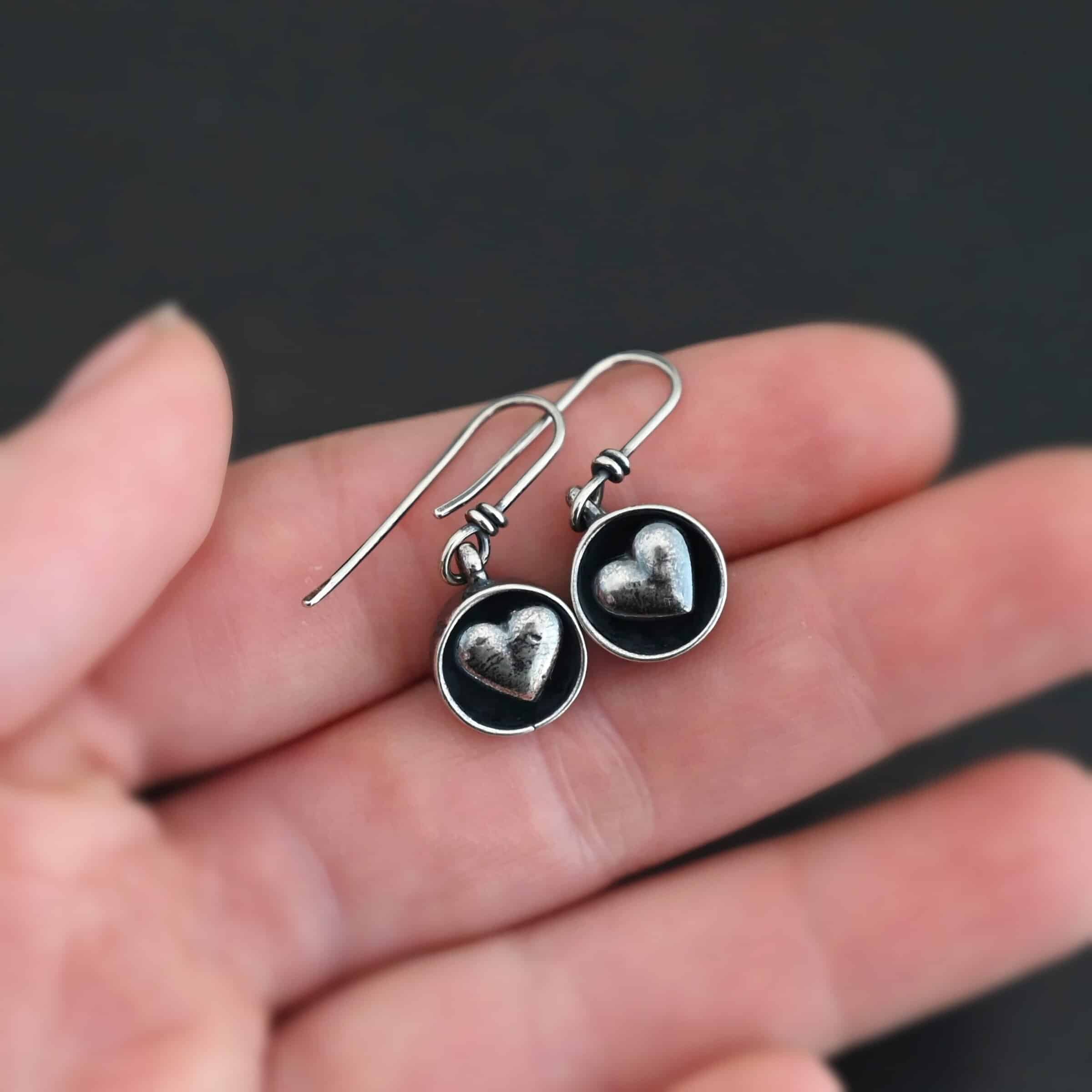 "Cups Of Love" Earrings. Earrings have sterling silver french hook ear wires. Hanging at the bottom of each is a small silver "cup" with a silver heart in the center of it.
