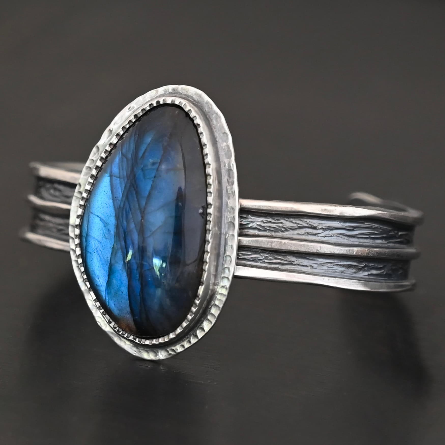 Deep Ocean Cuff "Deep Ocean" Cuff. Sterling Silver & Labradorite. There is an oval, vertical labradorite in the center with two hammered layers of sterling silver around it. The cuff has a thicker band, with a shiny line of silver down the middle and in between the shiny line is oxidized.