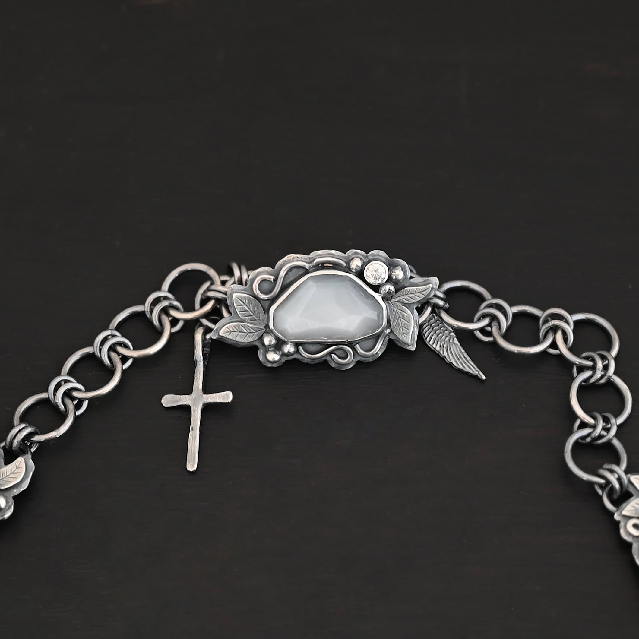 "Among The Stars" Necklace. One of the moonstones is used as a part of the clasp. There is a cross and angel wing charm on the back of the necklace.