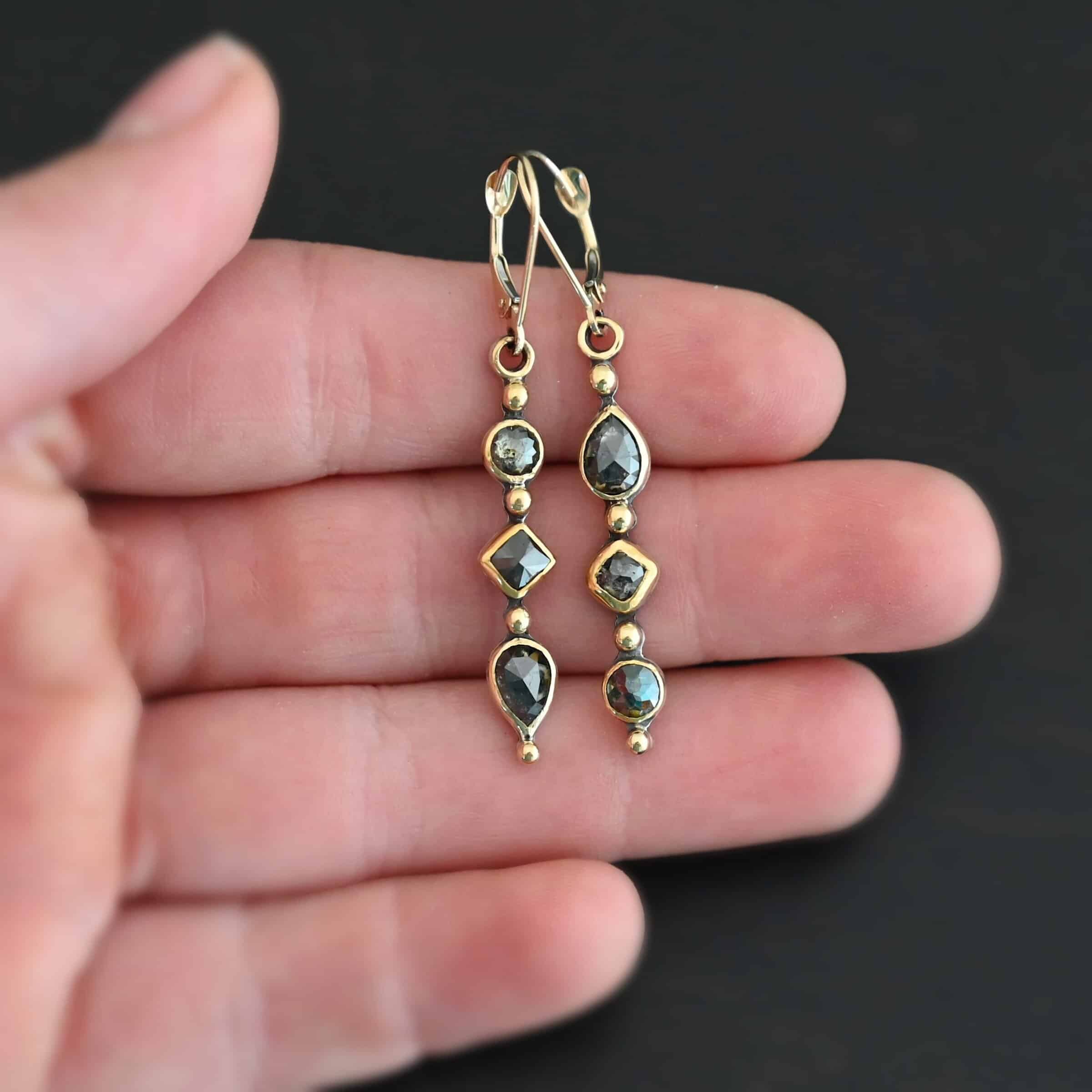 Zia Earrings "Zia" Earrings. Gold and Diamonds. Each earring has three brown diamonds. Each earring has four balls of gold separating the diamonds and above and below them. Earrings have gold ear wires.