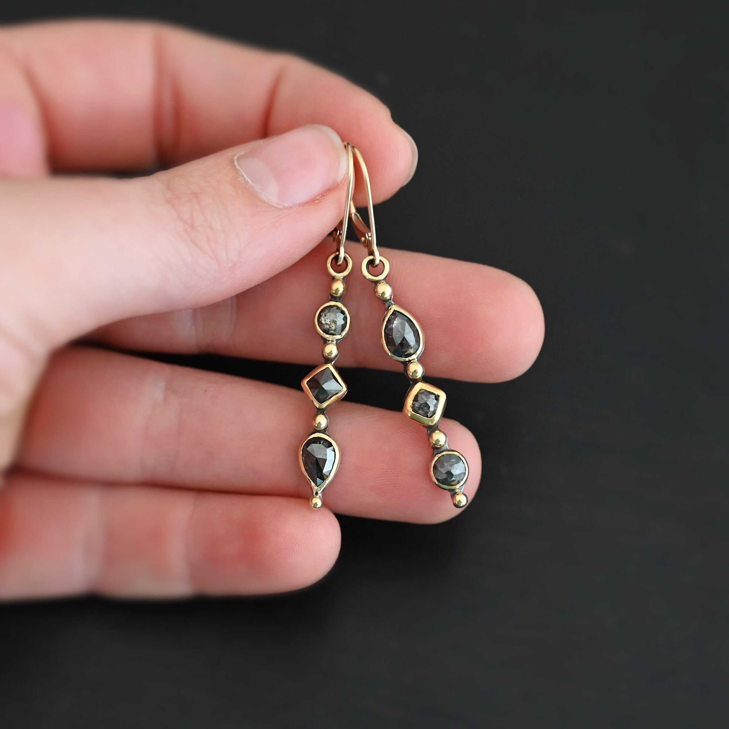 Zia Earrings "Zia" Earrings. Gold and Diamonds. Each earring has three brown diamonds. Each earring has four balls of gold separating the diamonds and above and below them. Earrings have gold ear wires.